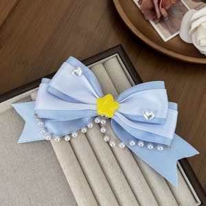 Blue Lolita bow hair clip with yellow star, white hearts and hanging pearl chain tassels