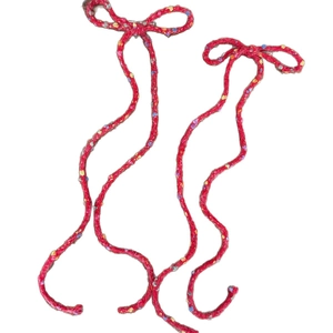 Ballet style red knitted bow hair clips with colorful speckled yarn and long tassels