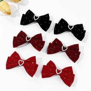 Velvet bow hair clips with rhinestone hearts in black and burgundy on white background