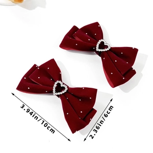 Detail of burgundy velvet bow hair clips with heart rhinestones and size dimensions