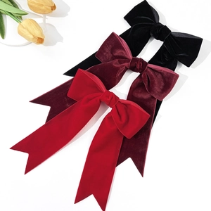 Elegant velvet bow hair clips with long ribbons in black, wine red, and red colors