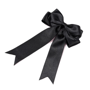 Elegant black satin bow hair clip with long ribbons on a minimalist white background