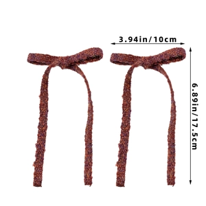 Detailed size view of red-brown knitted bow hair clips measuring 3.94 by 6.89 inches