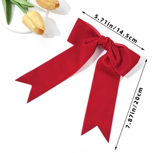 Detailed view of a large red velvet hair bow clip measuring 14.5cm wide and 20cm long