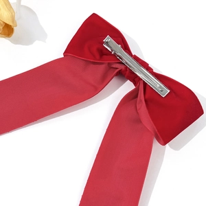 Elegant large red velvet bow hair clip with silver metal alligator clamp on white backdrop