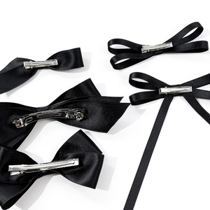 Elegant black satin bow hair clips in various styles with secure metal clasps for women