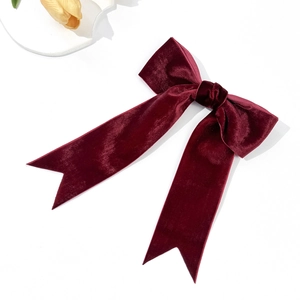 Elegant wine red velvet bow hair clip with swallowtail ribbon on white background