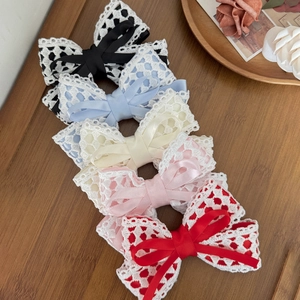 Set of 5 elegant lace bow hair clips in various colors on a rustic wooden background