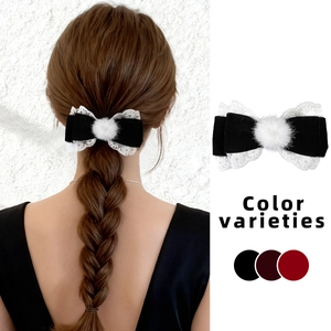 Sweet velvet lace bow hair clip with plush ball detail shown on hair and flat lay