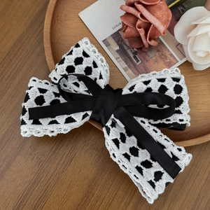 Elegant hollow lace bow hairclip with black ribbon and vintage aesthetic details