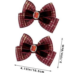 Detailed macro view of burgundy tweed bow hair clip with velvet and gemstone center