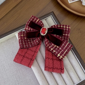 Elegant burgundy velvet and tweed bow hair clip featuring a sparkling faux crystal