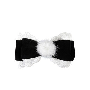 Elegant black velvet bow hair clip with white lace trim and center pom-pom detail