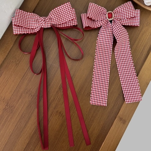Elegant red houndstooth bow hair clips with long ribbons and ruby rhinestone embellishment