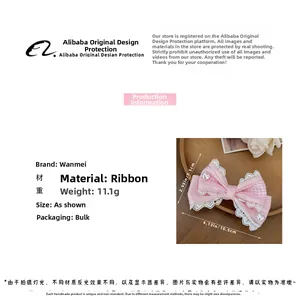 Roze Lolita strik haarclip met hartdetail en geruite lintstructuur detailweergave