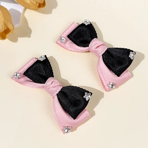 Pink and black satin bow hair clips with silver star rhinestones and elegant details