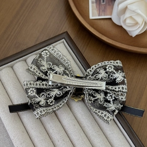 Elegant black lace bow hair clip with silver embroidery and gold-tone metal base