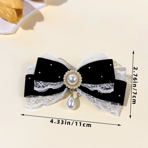 Detail view of a velvet lace bow hair clip with pearl pendant and size measurements