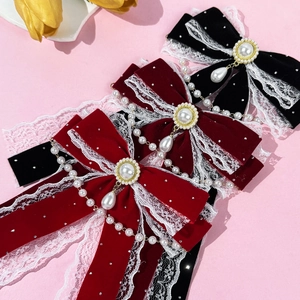French vintage velvet bow hair clips with pearls and lace trim on pink background