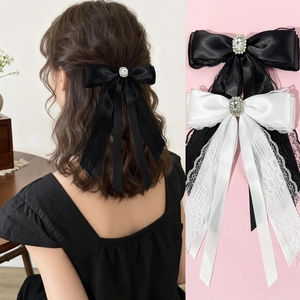 Elegant lace and satin bow hair clip with oval rhinestone center for stylish women's updos
