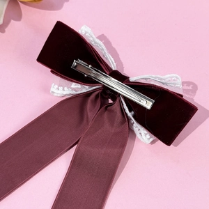Elegant burgundy velvet hair bow with white lace trim and silver metal duckbill clip