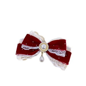 Red velvet Christmas bow hair clip with white lace edges and elegant pearl pendant accessory