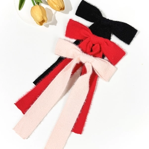 Elegant wool bow hair clips in black red and pink with soft fuzzy plush texture