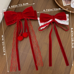 Elegant red velvet bow hair clips with white lace streamers and festive pompom details