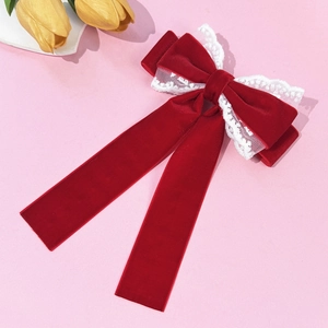 Elegant French vintage red velvet bow hair clip with white lace trim on pink background