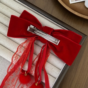 Elegant red velvet bow hair clip with lace ribbons and plush pompom charms for New Year