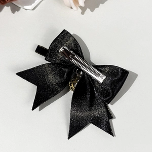 Dark gothic black bow hair clip with gold flower pendant and glitter finish