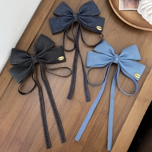 Three-piece denim bow hair clips in black, dark blue, and light blue with long ribbons