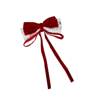 Elegant red velvet bow hair clip with white lace trim and long flowing ribbons