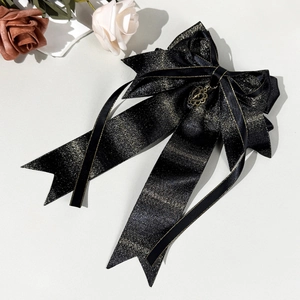 Elegant large black bow hair clip with gold glitter trim and hollow heart pendant