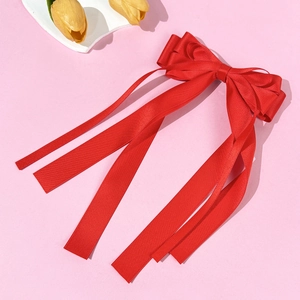 Elegant red satin bow hair clip with long ribbons and smooth silky texture for women