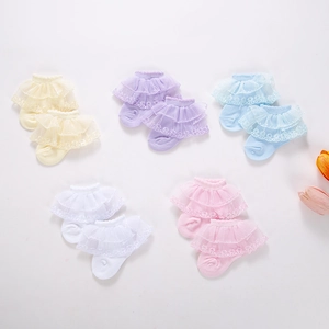 Detail of five pairs of baby lace socks in macaron colors with soft knitted texture