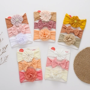 Detail of three-piece baby headband set with soft fabric bows and chiffon flowers on cards