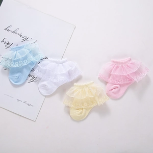 Detail showing baby cotton socks with double-layered lace frills in four pastel colors