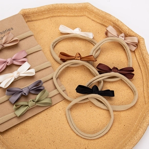 Detailed macro view of 10-piece baby nylon headbands with handmade ribbed bows