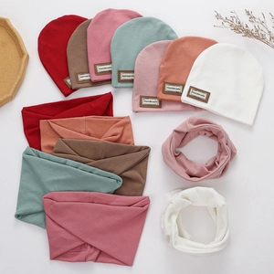 Detail of ribbed knit baby beanie and neck warmer set in multiple colors with leather label