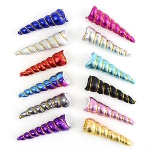 Close-up of glittery unicorn horns in various colors with golden spiral threads