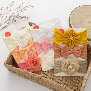 Three-piece baby headband set featuring soft fabric flowers and bows on display cards