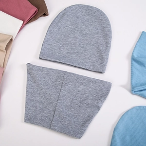 Detailed view of grey knitted beanie and neck warmer set with vertical ribbed texture