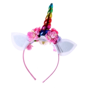 Detailed view of unicorn headband with iridescent horn and delicate silk flowers