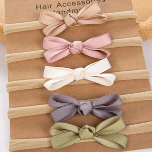 Detail of 5-piece handmade nylon baby headbands with soft satin bows in Morandi colors