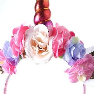 Close-up of floral unicorn headband with glittery horn and soft fabric flowers