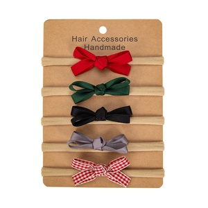 Detailed set of 5 handmade baby bows with solid colors and red plaid pattern on nylon bands