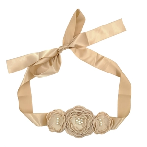 Détail de la ceinture en satin champagne avec trois fleurs faites main et perles