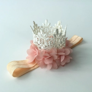 Close-up of baby crown headband with pink chiffon flower and white lace details