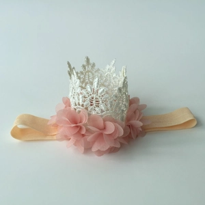Detail view of white lace crown and pink chiffon flower on soft elastic headband
